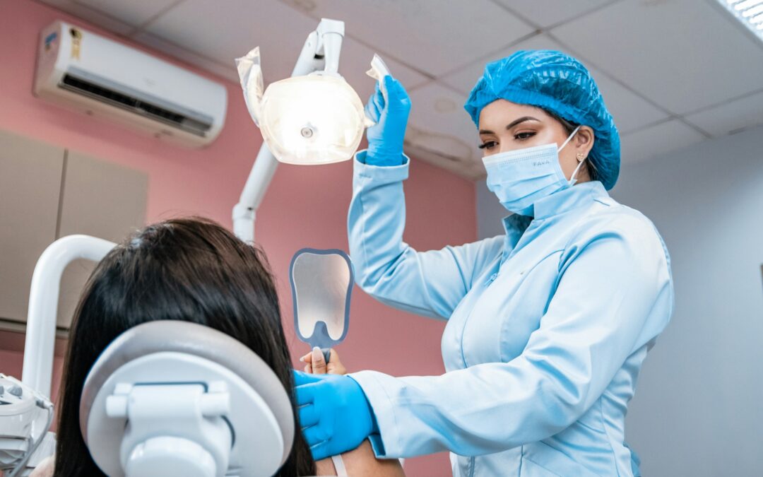 Dentist checking a patient's teeth to compare CEREC crown vs traditional crown options